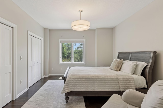 2 Red Forest Ln, North Oaks, MN 55127 - bedroom featuring dark wood-style floors and two closets
