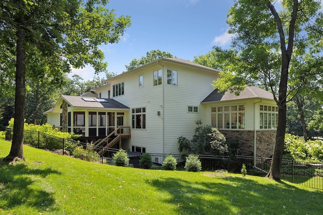 2 Red Forest Ln, North Oaks, MN 55127 - back of property with a sunroom, roof mounted solar panels, stairway, and stone siding
