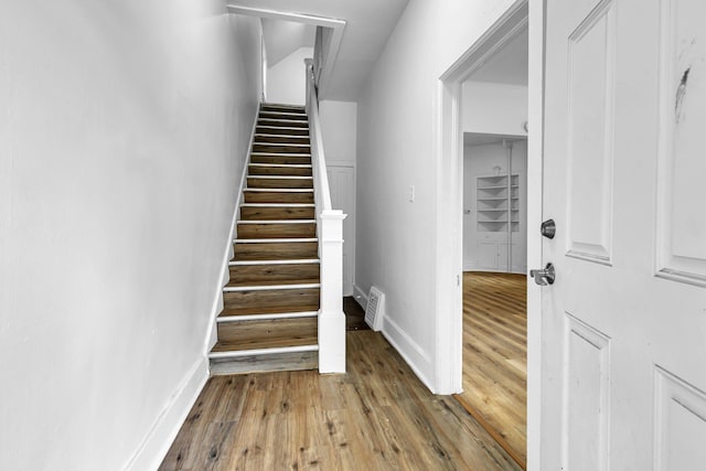 12 16th Ave N, Saint Cloud, MN 56303 - staircase featuring wood finished floors and baseboards