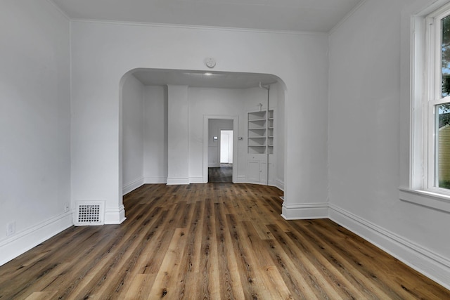 12 16th Ave N, Saint Cloud, MN 56303 - empty room with arched walkways, wood finished floors, crown molding, and a smoke detector