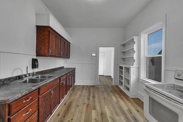 12 16th Ave N, Saint Cloud, MN 56303 - kitchen with white range with electric stovetop, dark countertops, light wood finished floors, a wainscoted wall, and reddish brown cabinets