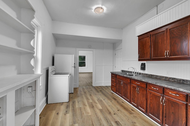 12 16th Ave N, Saint Cloud, MN 56303 - kitchen with washer / clothes dryer, open shelves, light wood-type flooring, and dark countertops