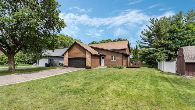 337 9 1/2 St N, Sauk Rapids, MN 56379 - view of front of home featuring an attached garage, a front yard, asphalt driveway, and roof with shingles