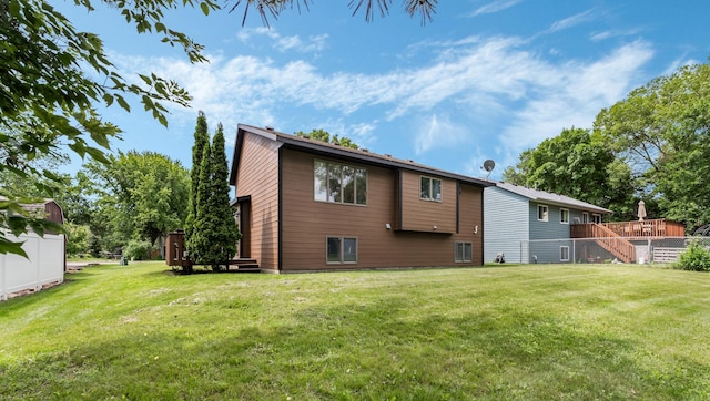 337 9 1/2 St N, Sauk Rapids, MN 56379 - back of house with a lawn and a wooden deck