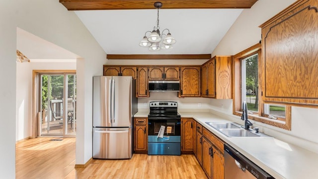 337 9 1/2 St N, Sauk Rapids, MN 56379 - kitchen with appliances with stainless steel finishes, vaulted ceiling, brown cabinets, light countertops, and light wood finished floors