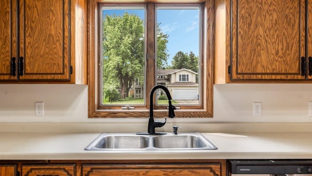 337 9 1/2 St N, Sauk Rapids, MN 56379 - kitchen with dishwashing machine, light countertops, healthy amount of natural light, and brown cabinets