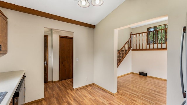 337 9 1/2 St N, Sauk Rapids, MN 56379 - interior space with light wood-style floors, vaulted ceiling, stairway, and a chandelier