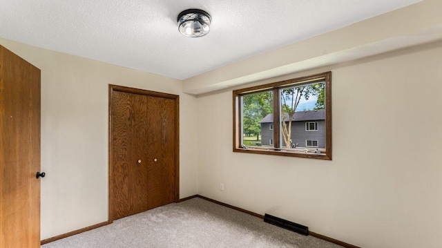 337 9 1/2 St N, Sauk Rapids, MN 56379 - unfurnished bedroom featuring carpet floors, a closet, and a textured ceiling