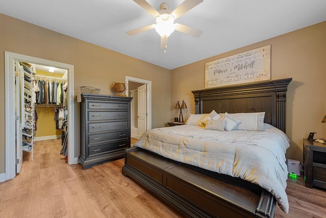 1904 Rock Ridge Ln, Saint Peter, MN 56082 - bedroom featuring a walk in closet, light wood-style flooring, a closet, and ceiling fan