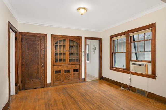 3809 41st Ave S, Minneapolis, MN 55406 - entryway featuring wood finished floors, ornamental molding, and cooling unit