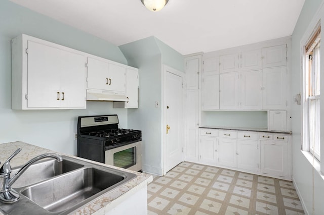 3809 41st Ave S, Minneapolis, MN 55406 - kitchen with gas range, under cabinet range hood, light floors, white cabinets, and plenty of natural light