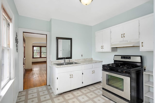 3809 41st Ave S, Minneapolis, MN 55406 - kitchen with stainless steel gas range oven, under cabinet range hood, light flooring, light countertops, and white cabinetry
