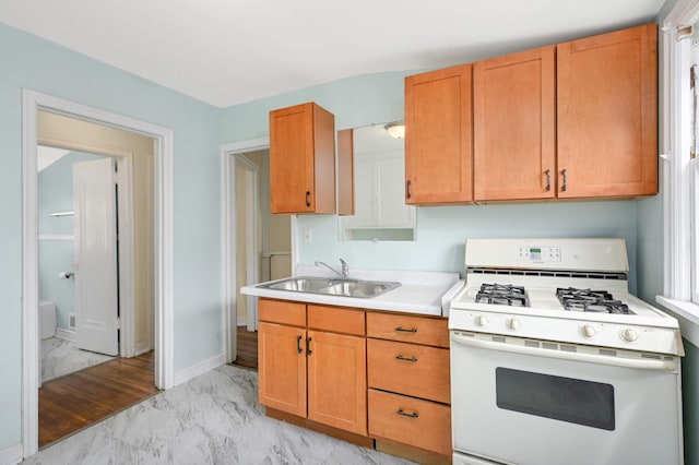3809 41st Ave S, Minneapolis, MN 55406 - kitchen with gas range gas stove, light marble finish flooring, light countertops, and brown cabinets