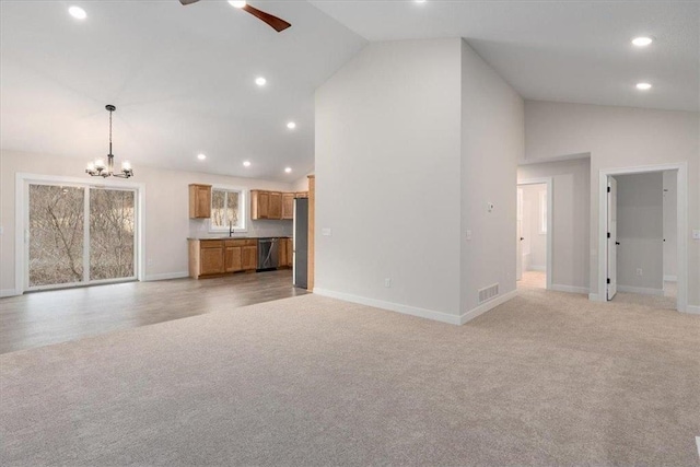 S1546 Shawnee Dr Unit B, Alma, WI 54610 - unfurnished living room with light colored carpet, a chandelier, a ceiling fan, recessed lighting, and high vaulted ceiling