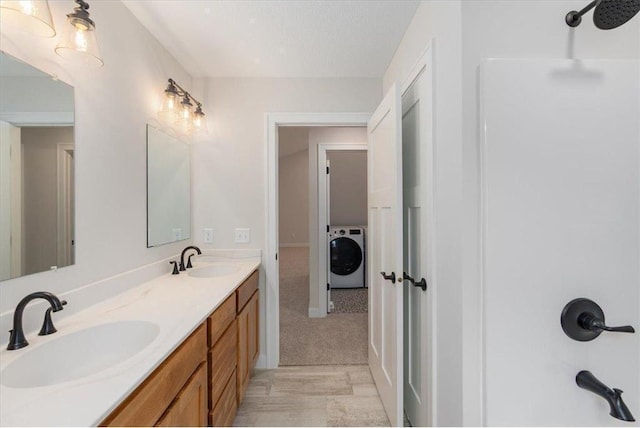 S1546 Shawnee Dr Unit B, Alma, WI 54610 - bathroom featuring washer / dryer, double vanity, and a shower