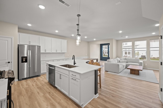 2570 Paddock Path, Shakopee, MN 55379 - kitchen with appliances with stainless steel finishes, white cabinets, recessed lighting, light wood-type flooring, and light countertops