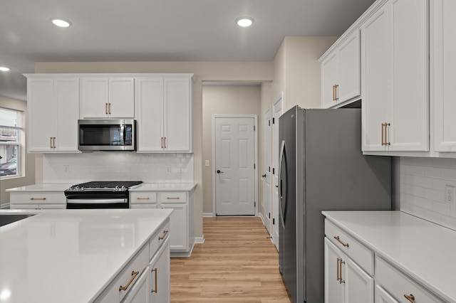 2570 Paddock Path, Shakopee, MN 55379 - kitchen with appliances with stainless steel finishes, white cabinetry, light wood-style floors, light countertops, and recessed lighting