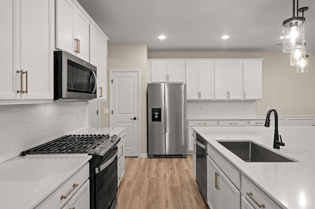 2570 Paddock Path, Shakopee, MN 55379 - kitchen featuring appliances with stainless steel finishes, light countertops, white cabinetry, decorative backsplash, and decorative light fixtures