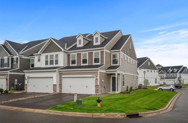 2570 Paddock Path, Shakopee, MN 55379 - townhome / multi-family property with an attached garage, driveway, a front yard, a residential view, and stone siding