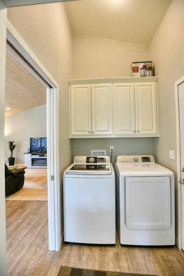 30534 County Highway 12, Dalton, MN 56324 - laundry area featuring cabinet space, separate washer and dryer, and light wood-style floors