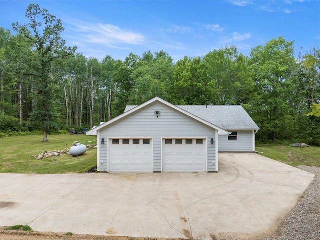 6629 45th Ave SW, Moose Lake Twp, MN 56472 - view of side of home with a lawn, a detached garage, and a forest view
