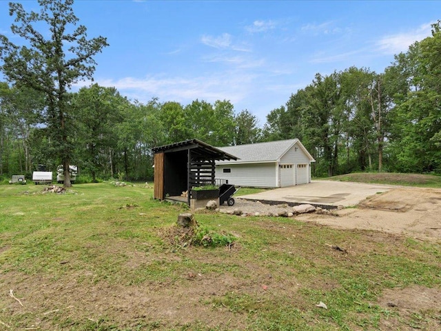 6629 45th Ave SW, Moose Lake Twp, MN 56472 - view of green lawn featuring an outbuilding and a garage