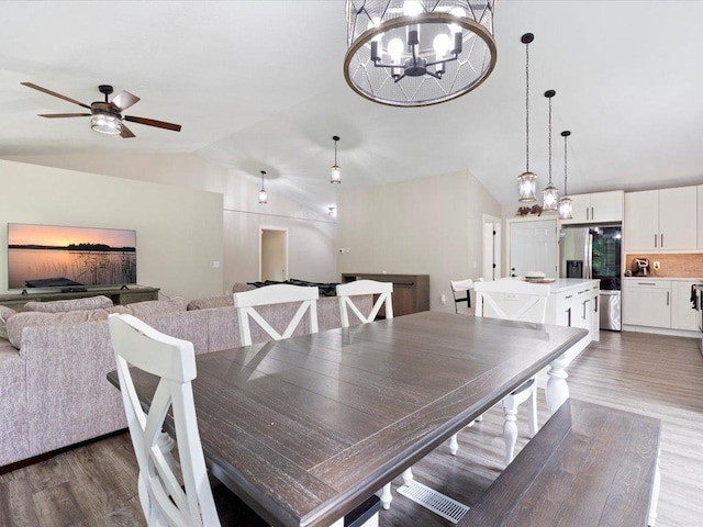 6629 45th Ave SW, Moose Lake Twp, MN 56472 - dining area with vaulted ceiling, dark wood-type flooring, a chandelier, and ceiling fan