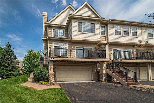 4363 Victor Path Unit 7, Hugo, MN 55038 - view of front facade featuring a chimney, a garage, asphalt driveway, and stairs