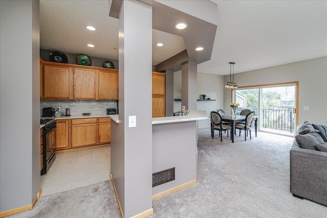 4363 Victor Path Unit 7, Hugo, MN 55038 - kitchen featuring black gas stove, light colored carpet, recessed lighting, open floor plan, and backsplash