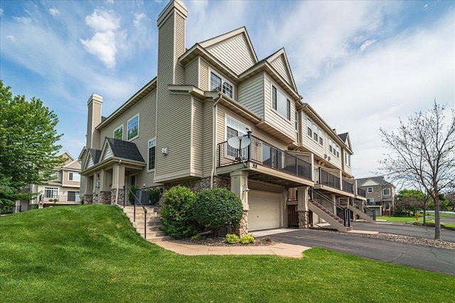 4363 Victor Path Unit 7, Hugo, MN 55038 - view of property exterior with a chimney, stone siding, a lawn, an attached garage, and stairway