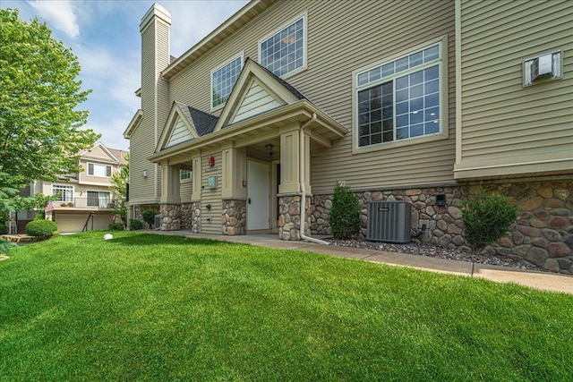 4363 Victor Path Unit 7, Hugo, MN 55038 - view of front of home with a chimney, a front lawn, and stone siding