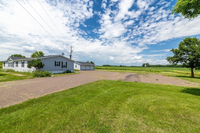 6257 State Highway 70, Rock Creek, MN 55063 - view of green lawn with driveway and a garage