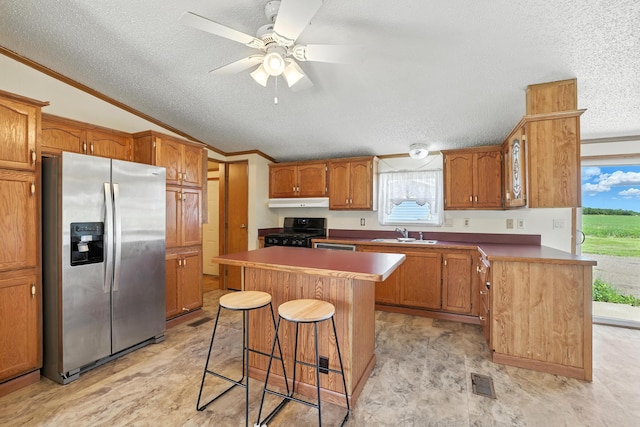 6257 State Highway 70, Rock Creek, MN 55063 - kitchen with stainless steel refrigerator with ice dispenser, black stove, a textured ceiling, crown molding, and lofted ceiling