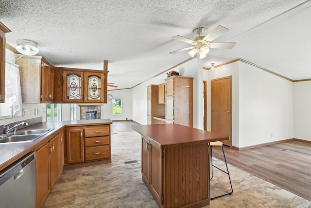 6257 State Highway 70, Rock Creek, MN 55063 - kitchen with stainless steel dishwasher, ceiling fan, ornamental molding, a textured ceiling, and a fireplace