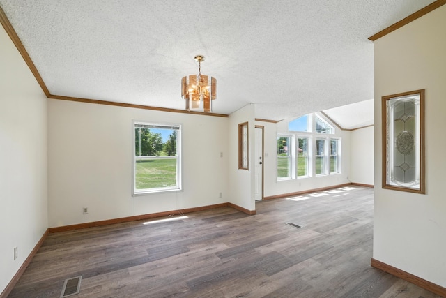 6257 State Highway 70, Rock Creek, MN 55063 - unfurnished living room with a chandelier, a textured ceiling, plenty of natural light, wood finished floors, and ornamental molding