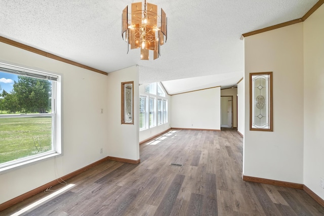 6257 State Highway 70, Rock Creek, MN 55063 - unfurnished living room with wood finished floors, a chandelier, a textured ceiling, crown molding, and vaulted ceiling