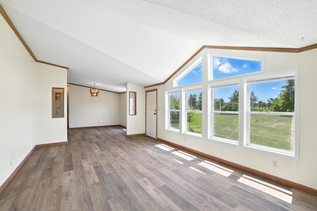 6257 State Highway 70, Rock Creek, MN 55063 - unfurnished living room featuring a chandelier, wood finished floors, a textured ceiling, lofted ceiling, and ornamental molding