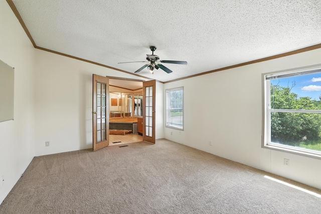 6257 State Highway 70, Rock Creek, MN 55063 - empty room featuring crown molding, plenty of natural light, carpet, a ceiling fan, and french doors