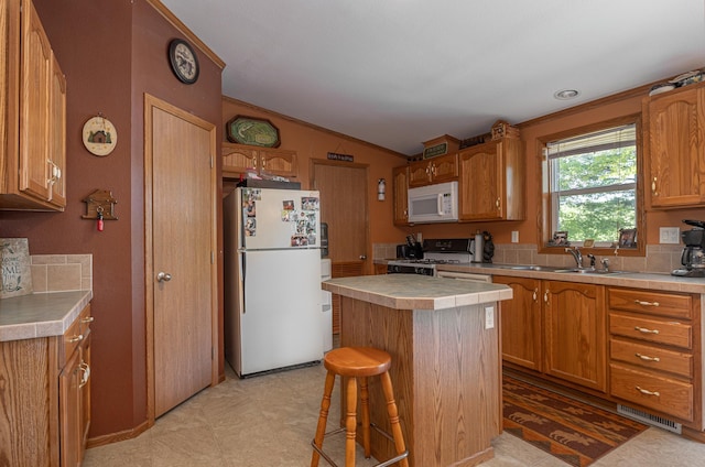 1618 Maple Shores Ln NE, Longville, MN 56655 - kitchen featuring white appliances, lofted ceiling, a center island, a breakfast bar area, and tile counters