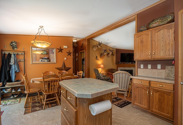 1618 Maple Shores Ln NE, Longville, MN 56655 - kitchen with a center island, brown cabinets, light countertops, and crown molding