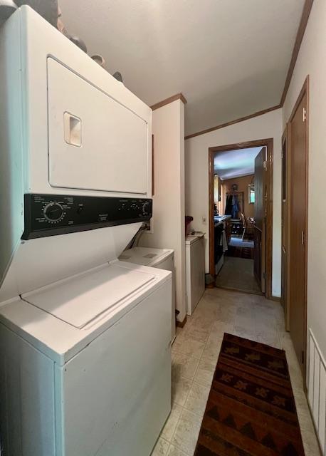 1618 Maple Shores Ln NE, Longville, MN 56655 - laundry room featuring stacked washer / drying machine and ornamental molding