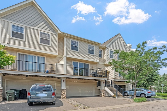 13659 Brick Path, Rosemount, MN 55068 - townhome / multi-family property featuring asphalt driveway, a garage, a chimney, and stone siding