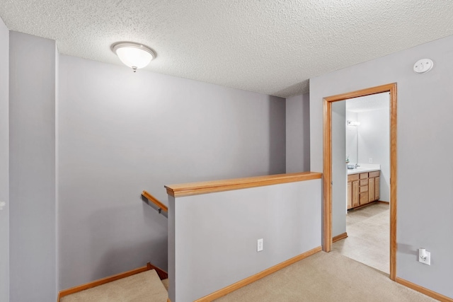 13659 Brick Path, Rosemount, MN 55068 - hallway featuring an upstairs landing, a textured ceiling, and light carpet