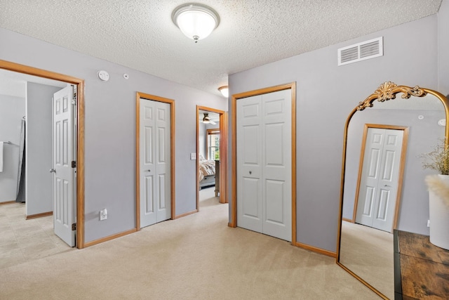 13659 Brick Path, Rosemount, MN 55068 - unfurnished bedroom featuring a textured ceiling, two closets, and light colored carpet