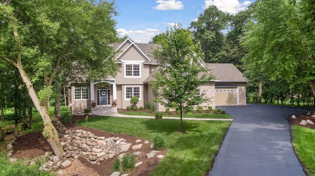 3027 135th Ave NE, Ham Lake, MN 55304 - obstructed view of property with driveway, a front yard, and an attached garage