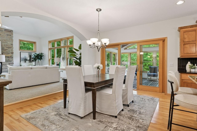 3027 135th Ave NE, Ham Lake, MN 55304 - dining space featuring arched walkways, a chandelier, light wood-style flooring, and recessed lighting