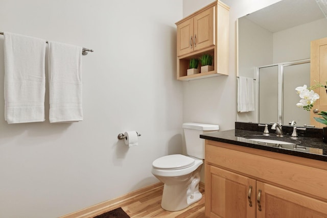 3027 135th Ave NE, Ham Lake, MN 55304 - bathroom with a stall shower, vanity, and wood finished floors