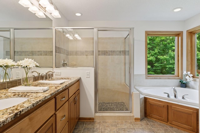 3027 135th Ave NE, Ham Lake, MN 55304 - full bathroom with double vanity, a stall shower, and a garden tub