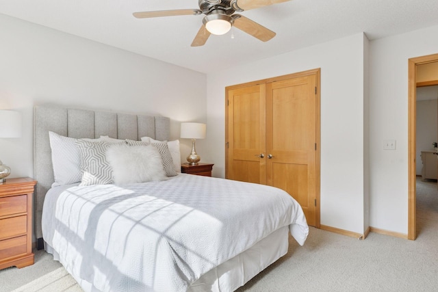 3027 135th Ave NE, Ham Lake, MN 55304 - bedroom featuring a closet, light colored carpet, and ceiling fan