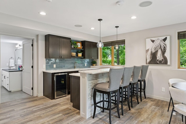 3027 135th Ave NE, Ham Lake, MN 55304 - indoor wet bar featuring wine cooler, plenty of natural light, light wood-style floors, backsplash, and recessed lighting